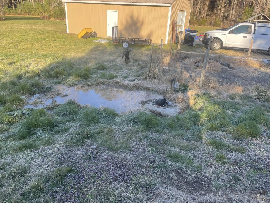 Flooded ground on ground over septic tank before repair
