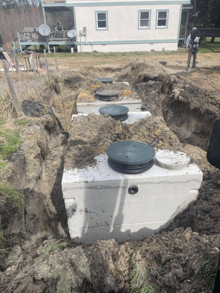 Two septic tanks dug out in the ground being repaired